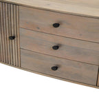 Wooden dresser with three drawers and black knobs on a white background