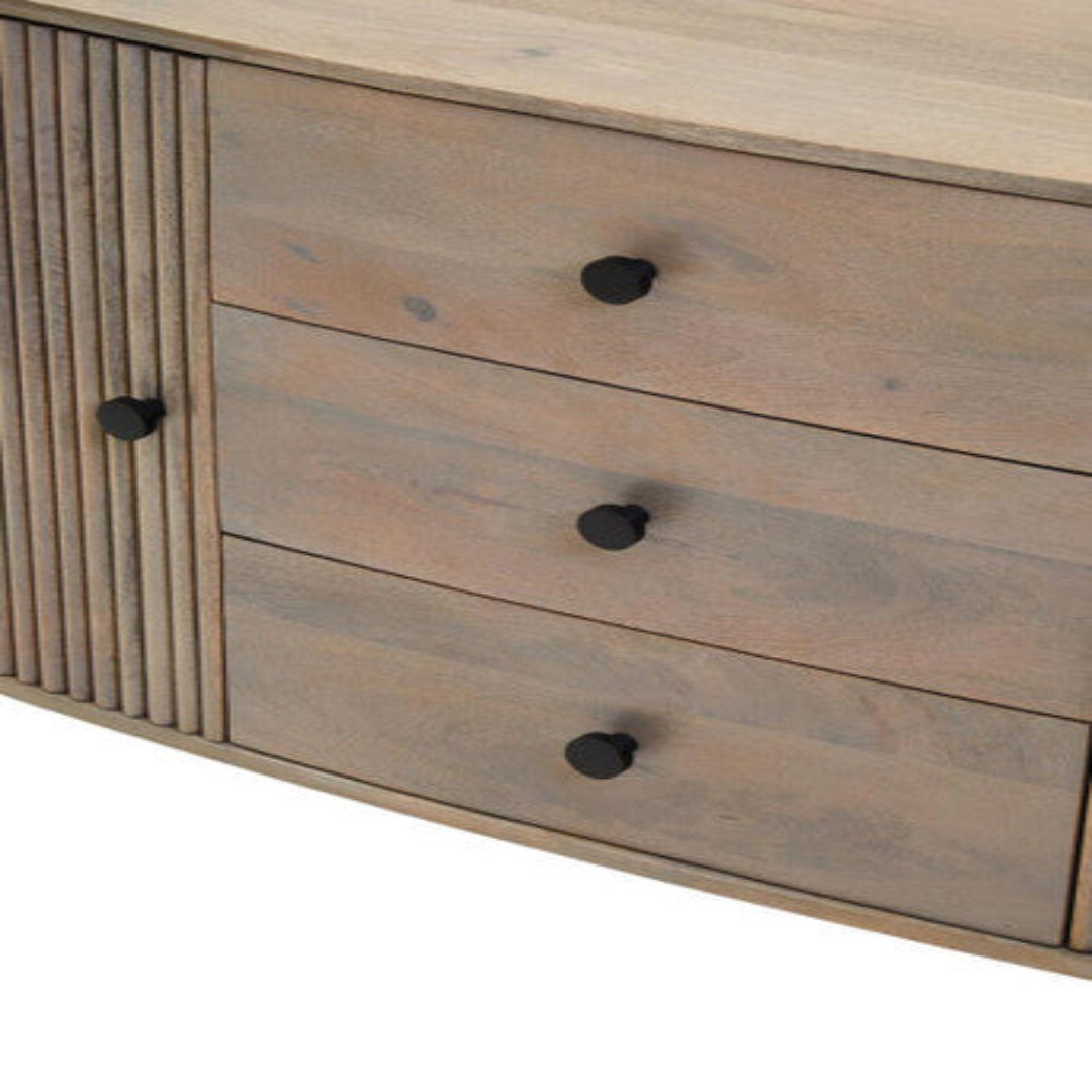 Wooden dresser with three drawers and black knobs on a white background
