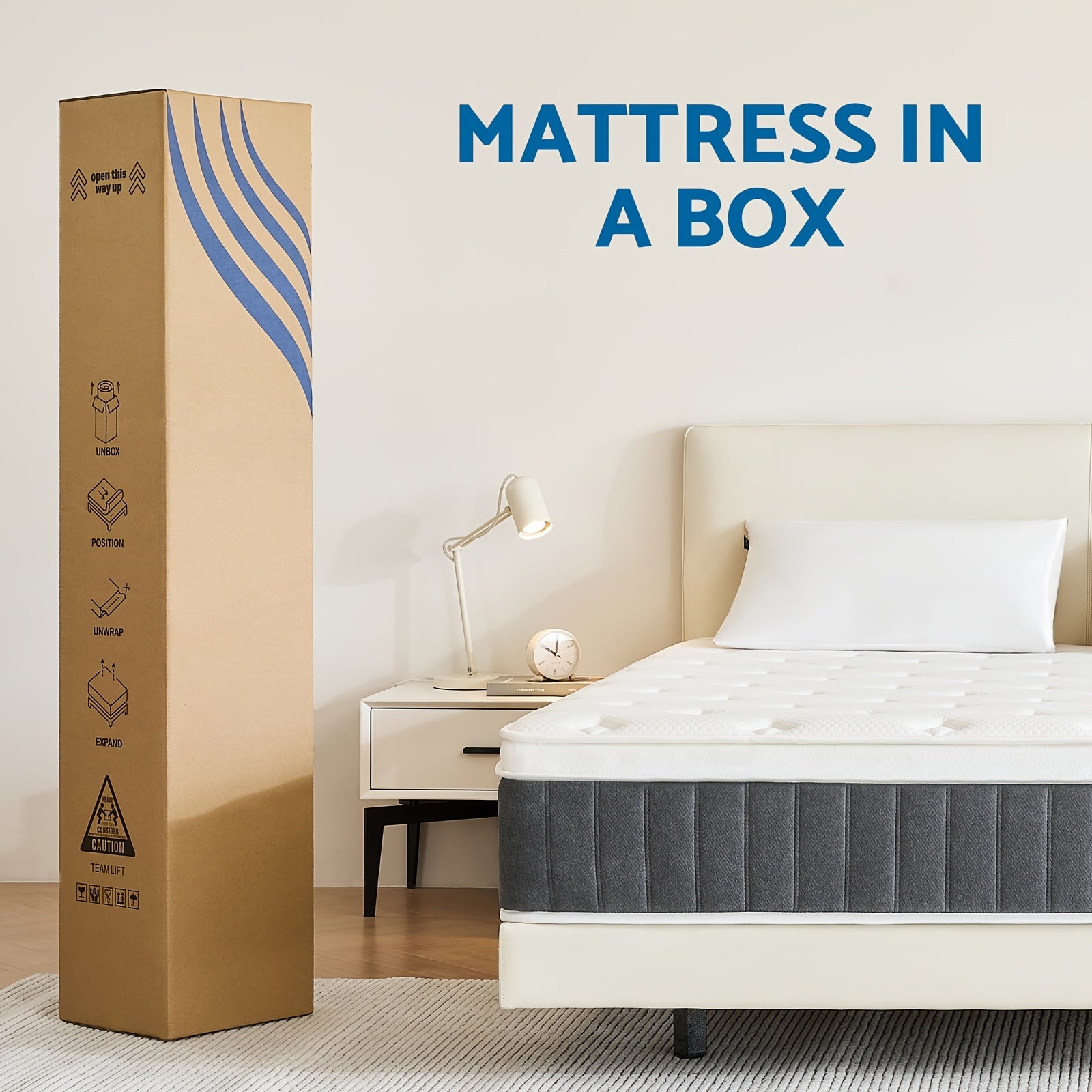 Mattress in a box with a large cardboard packaging box next to a bed in a bedroom setting.