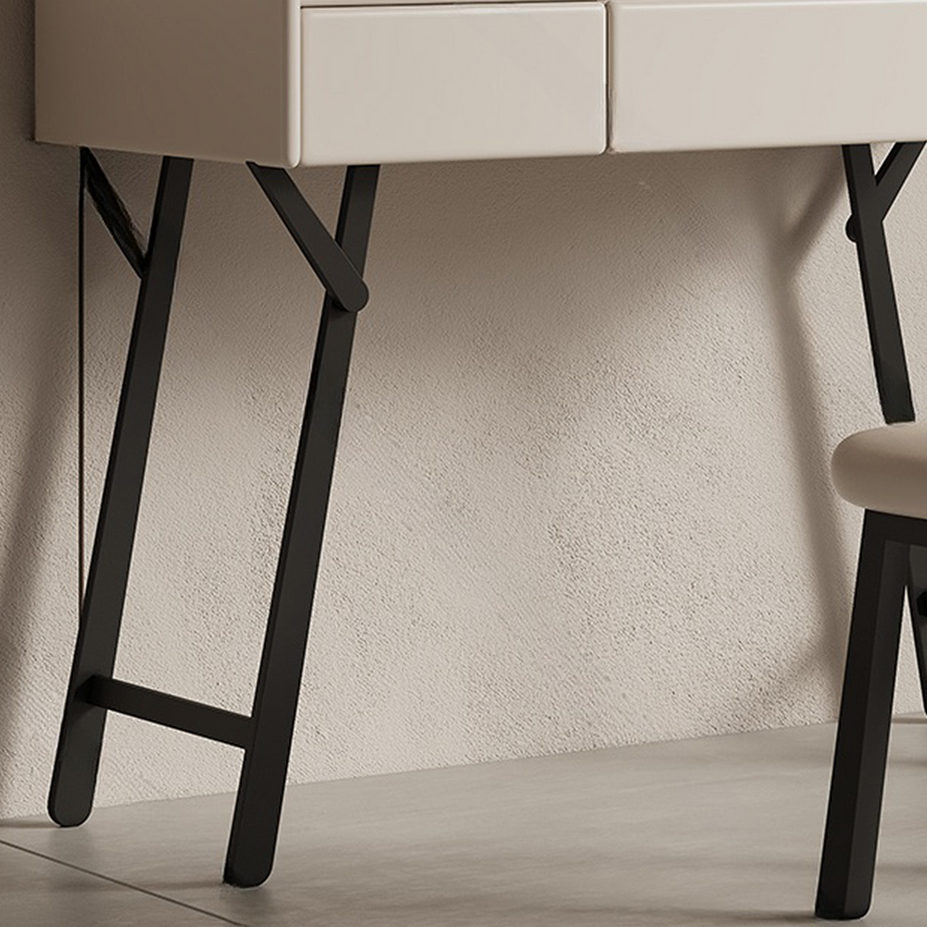Close-up of a modern desk with black legs against a textured wall.