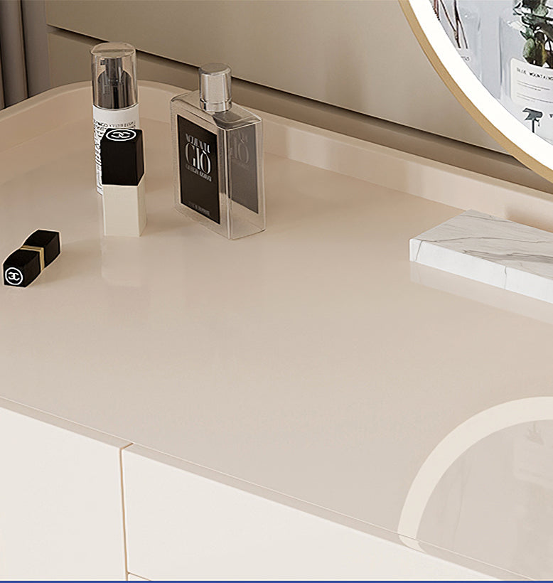 Makeup products on a vanity table with a mirror in the background