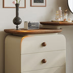 Beige dresser with wooden top and drawers, featuring a Marshall amplifier and decorative items.