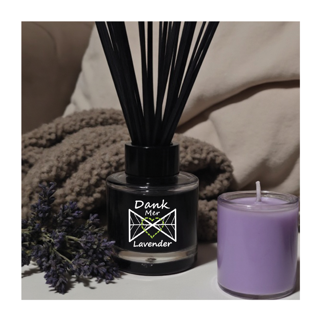Black diffuser with lavender flowers and a purple candle on a neutral background