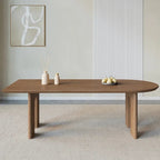 Wooden dining table with decorative items in a minimalistic room.