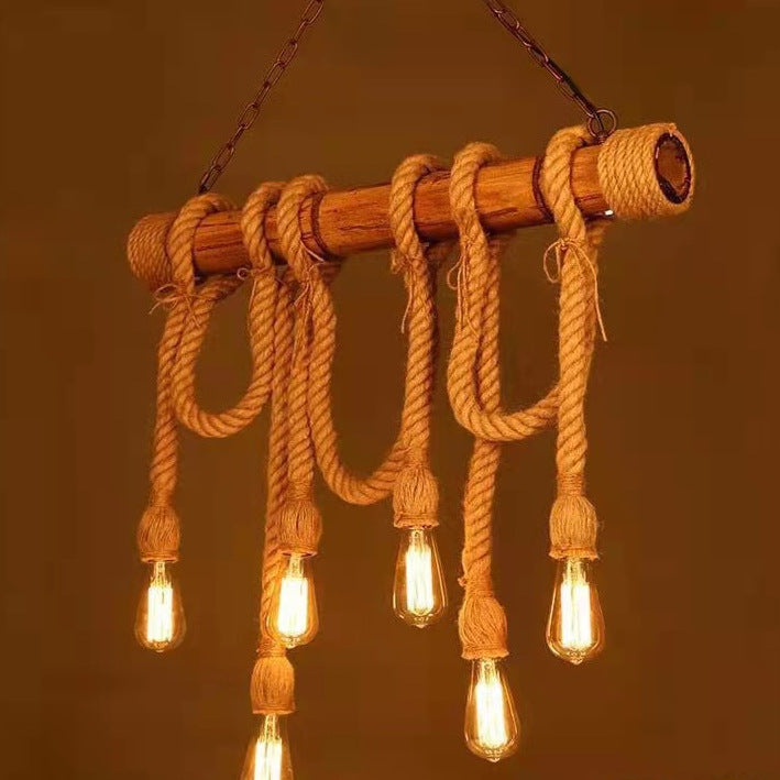 Rustic pendant light with braided rope and vintage-style bulbs on a warm brown background