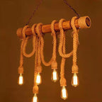 Rustic pendant light with braided rope and vintage-style bulbs on a warm brown background