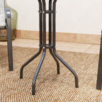 Black metal stand on a textured floor with a neutral wall background
