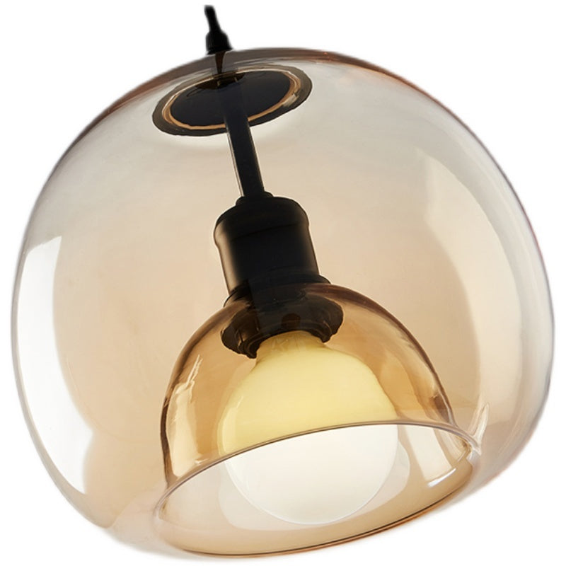 Amber glass pendant light with black fixture on a white background