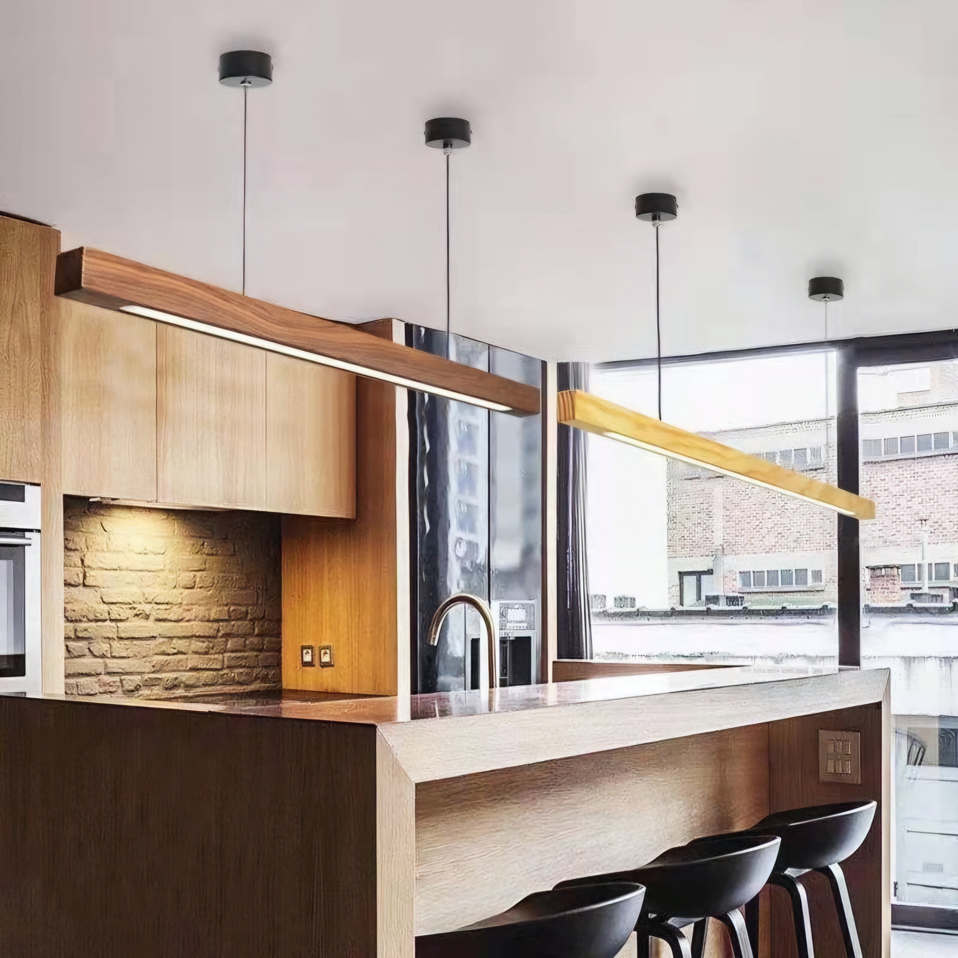 Modern kitchen with wooden cabinets, stone backsplash, and pendant lights.