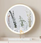 Round illuminated mirror with decorative plants in the reflection on a neutral background