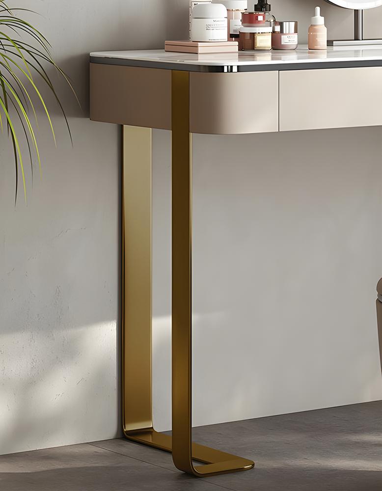 Modern console table with gold legs against a neutral wall