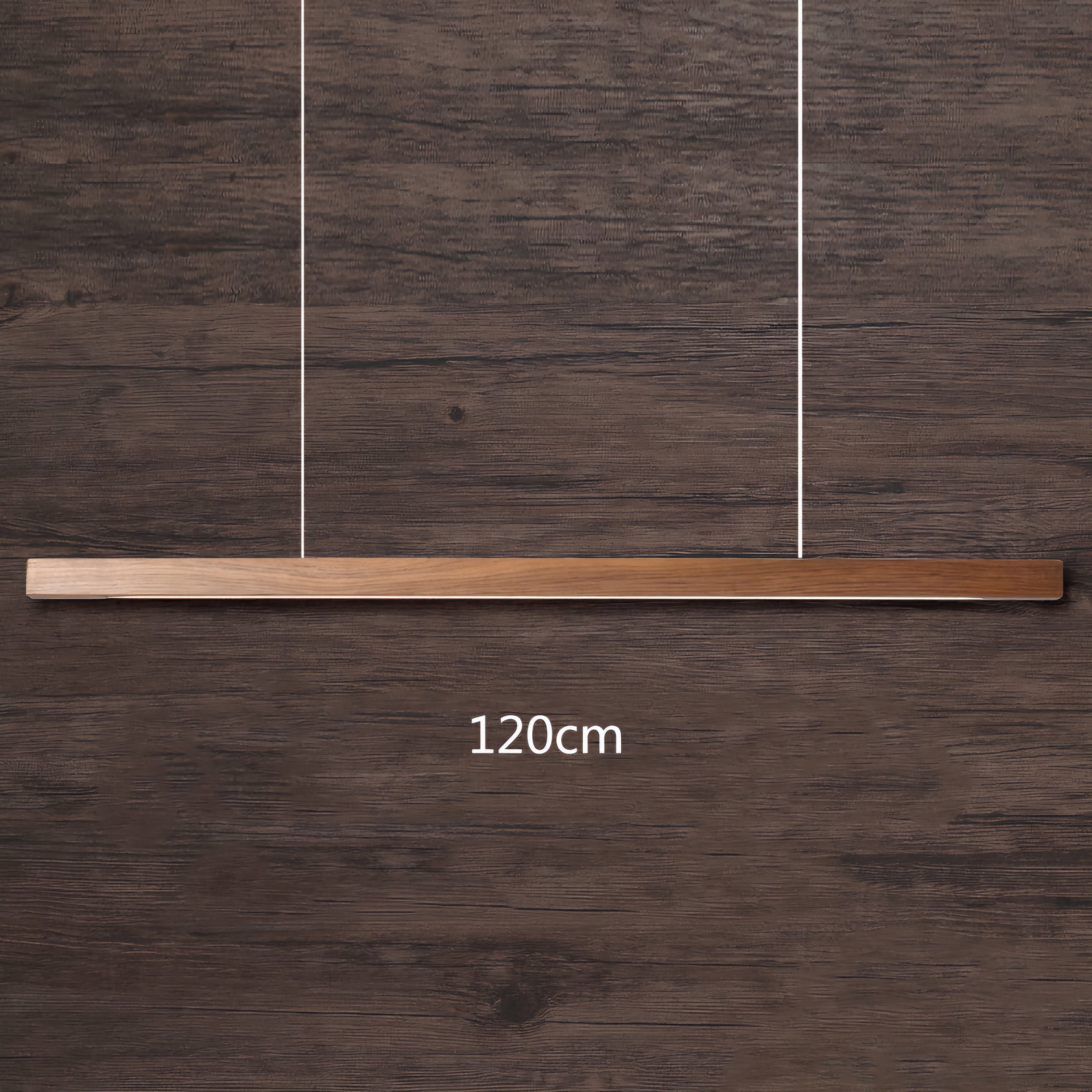A modern linear pendant light with a brushed brass or bronze horizontal bar suspended by two thin vertical wires, shown against a dark brown wood plank background with a '120cm' size overlay.