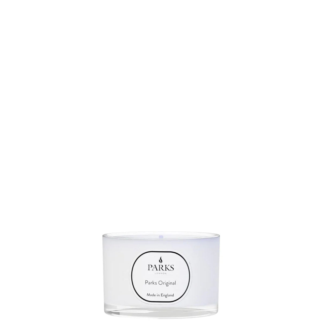 Clear glass candle with 'Parks' branding on a white background