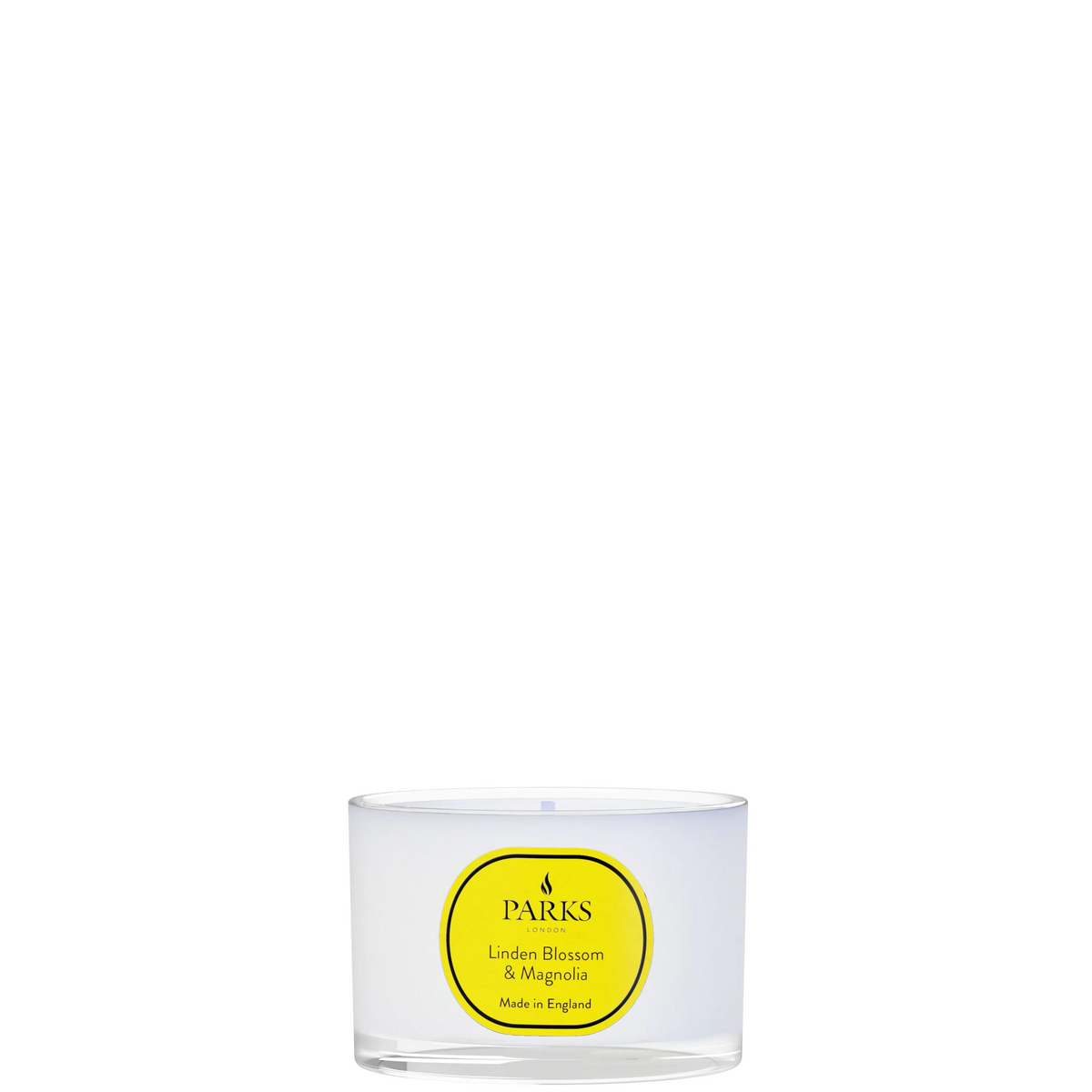Clear glass candle with a yellow label on a white background