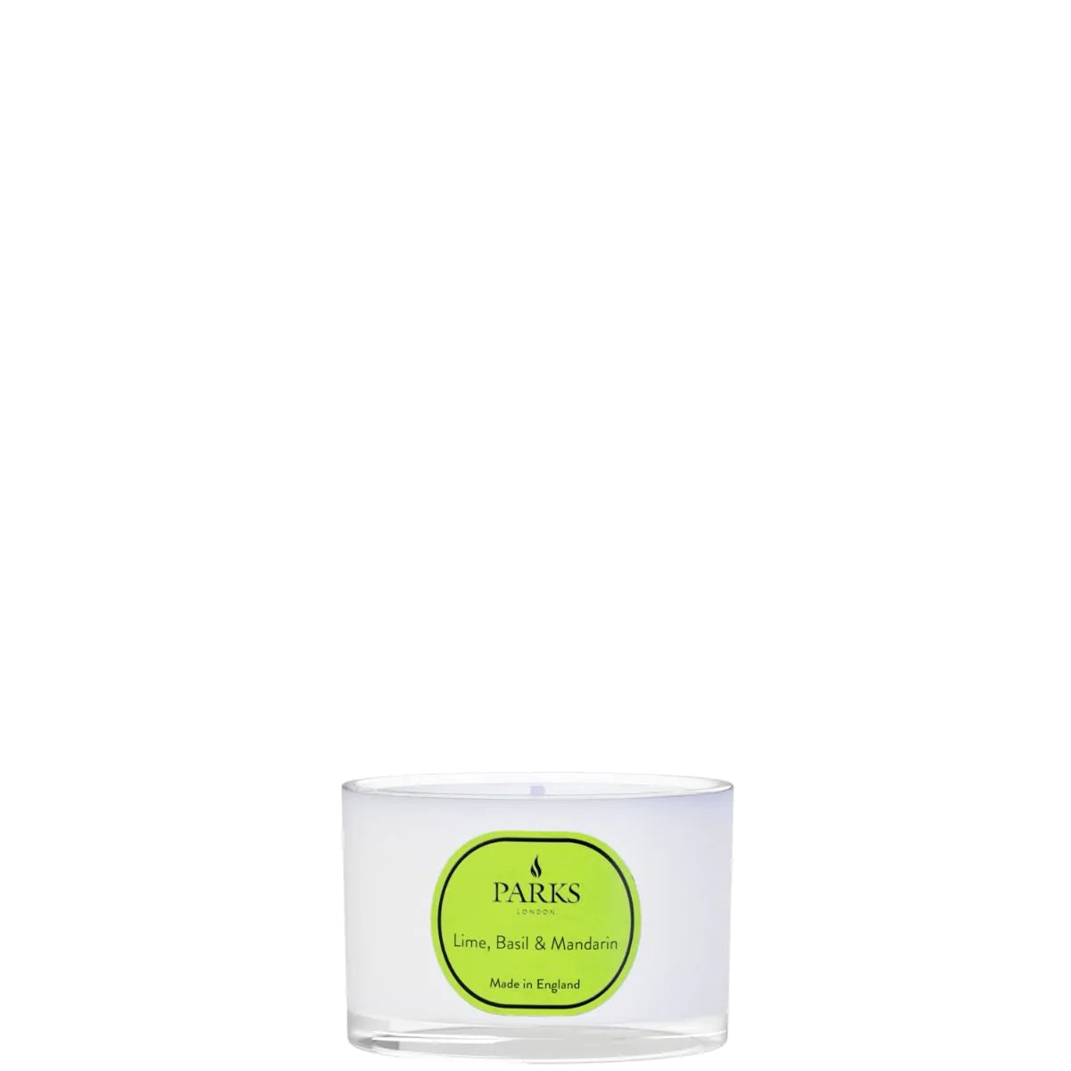 Clear glass candle with a green label on a white background