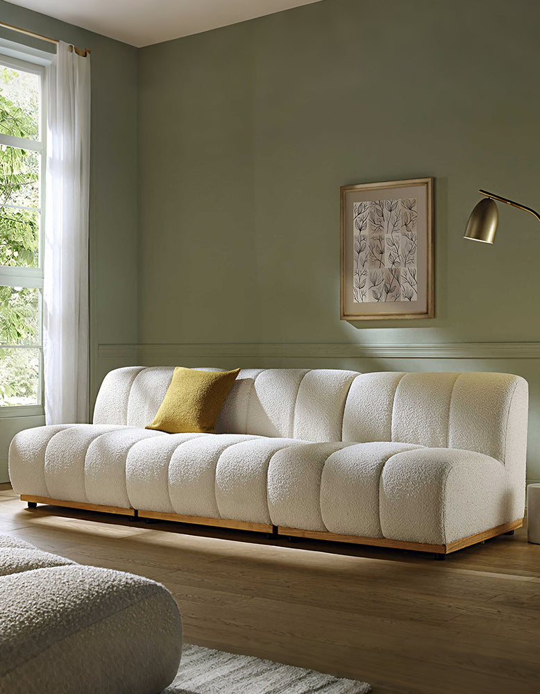 White sofa with a yellow pillow in a living room setting