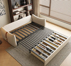 Beige upholstered bed with metal frame in a room with wooden floor and window blinds.