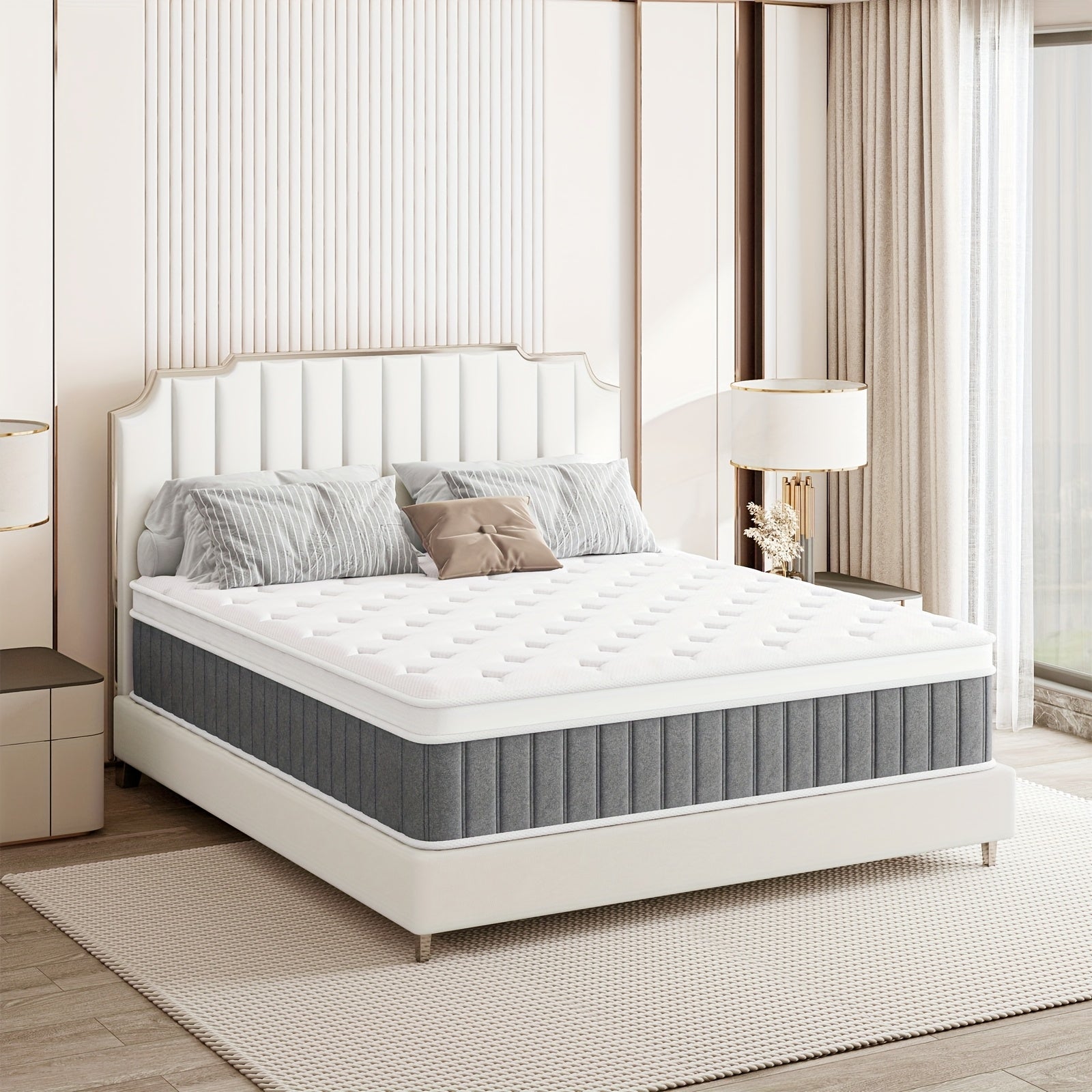 White bed with gray mattress cover in a bedroom setting