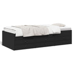 Black bed frame with white bedding on a white background