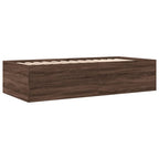 Wooden bed frame with storage drawers on a white background