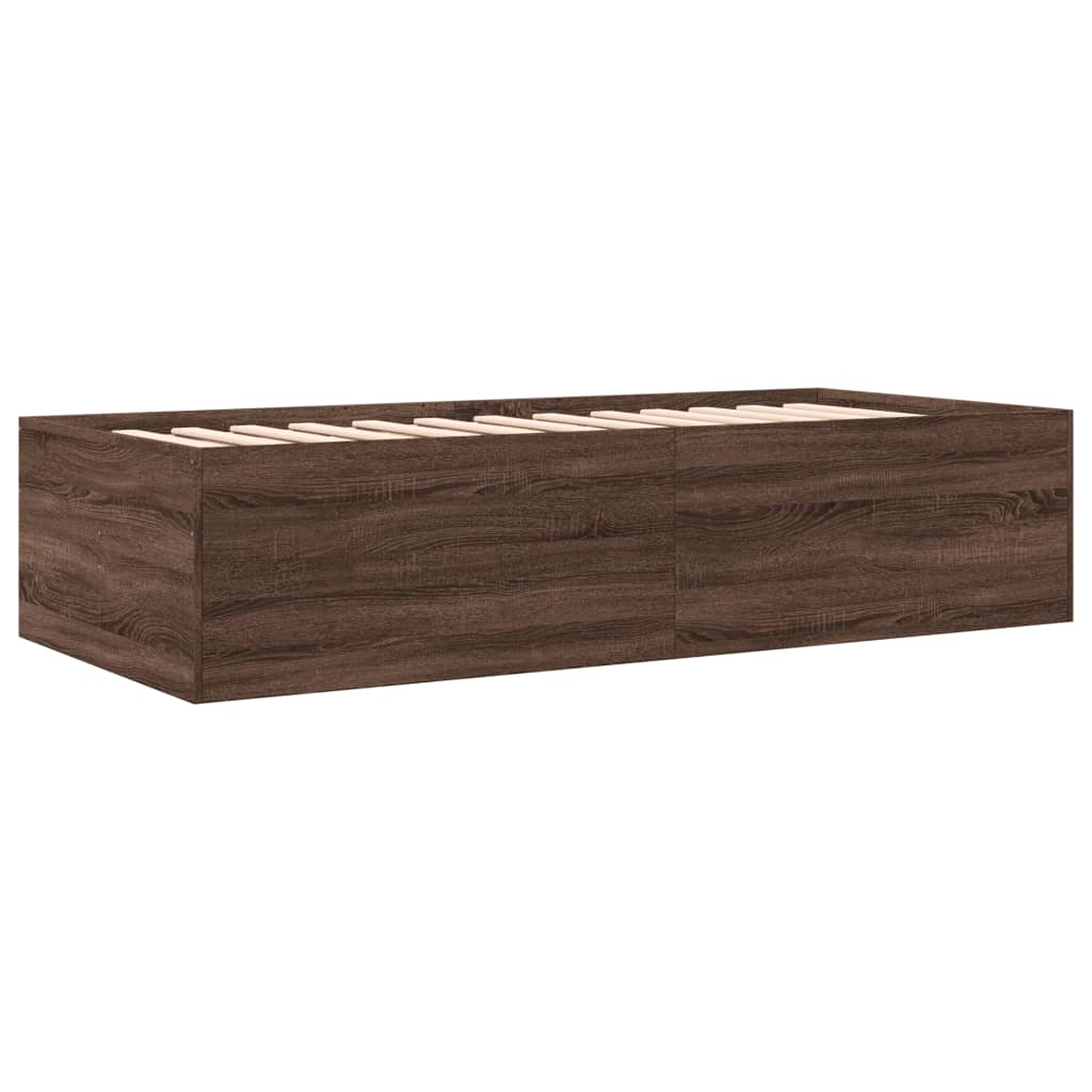 Wooden bed frame with storage drawers on a white background
