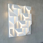 Geometric wall art with lighting on a gray wall