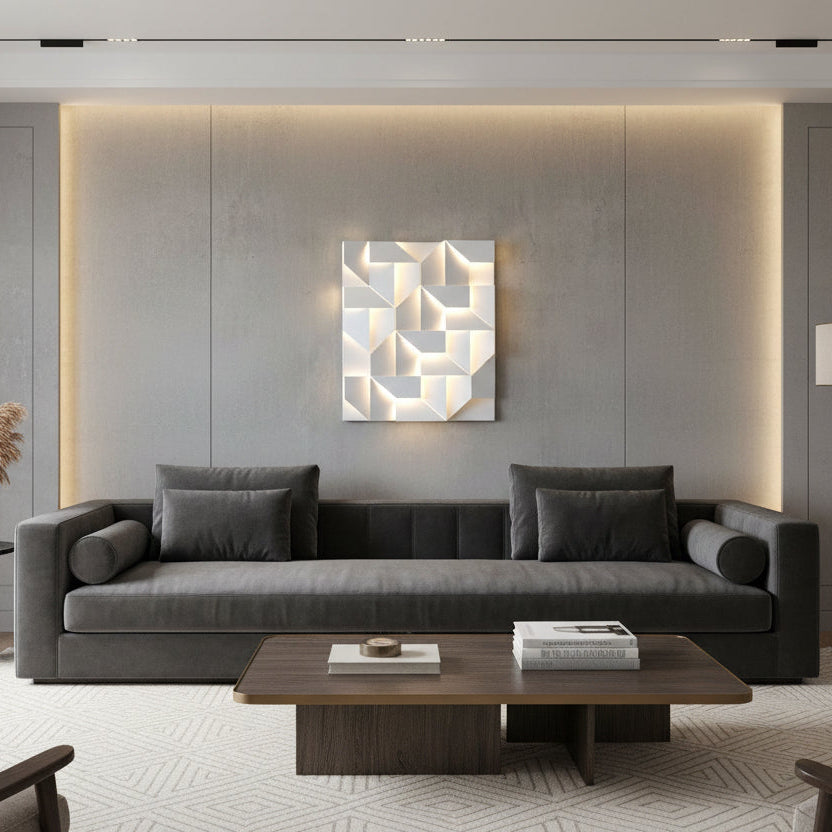 Modern living room with a gray sectional sofa, wooden coffee table, and abstract wall art.