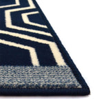 Navy blue and white geometric patterned rug corner