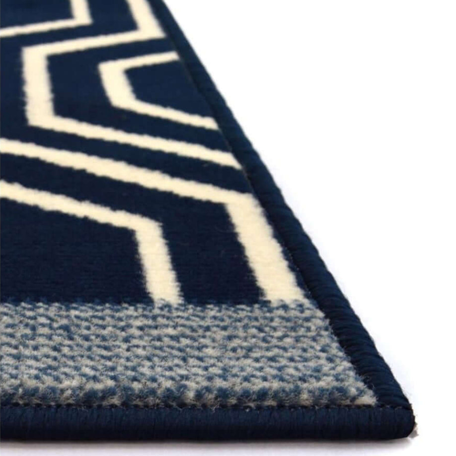 Navy blue and white geometric patterned rug corner