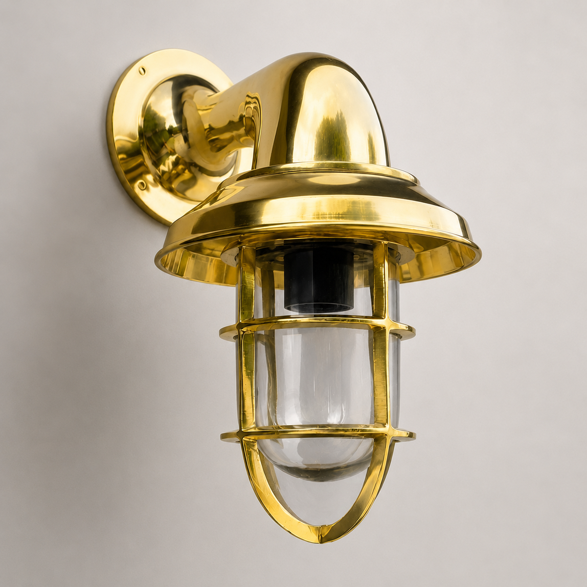 Gold outdoor wall light fixture on a gray background