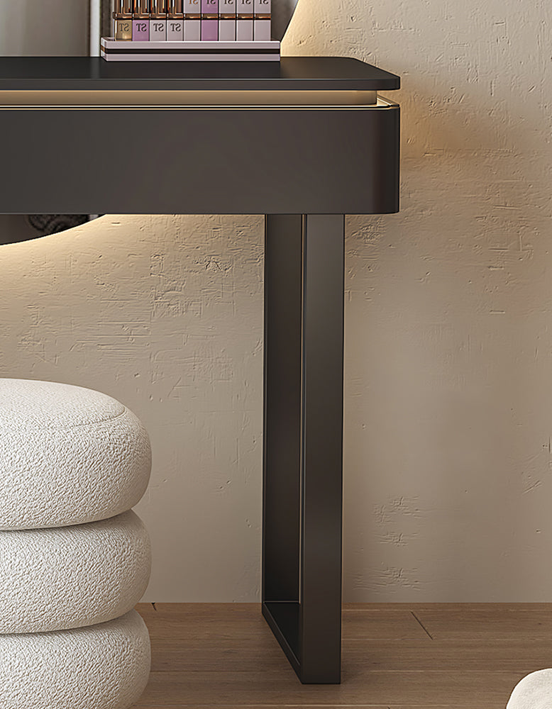 Modern black console table against a beige wall with a textured surface.