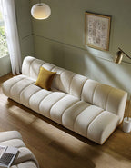 Beige sofa with a yellow pillow in a living room setting