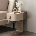 Beige side table with a drawer next to a beige sofa in a room.