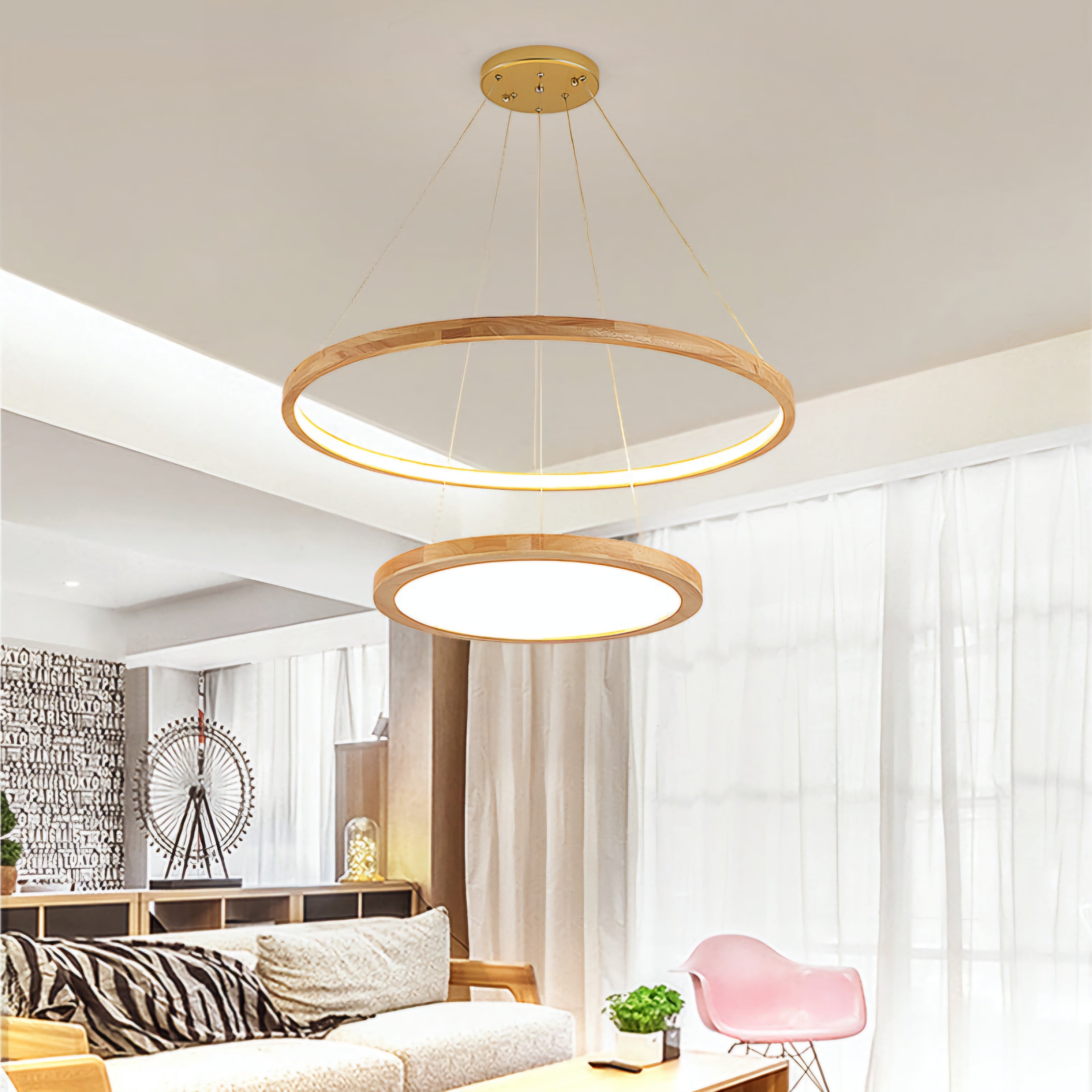Modern living room with two wooden pendant lights and a pink chair.