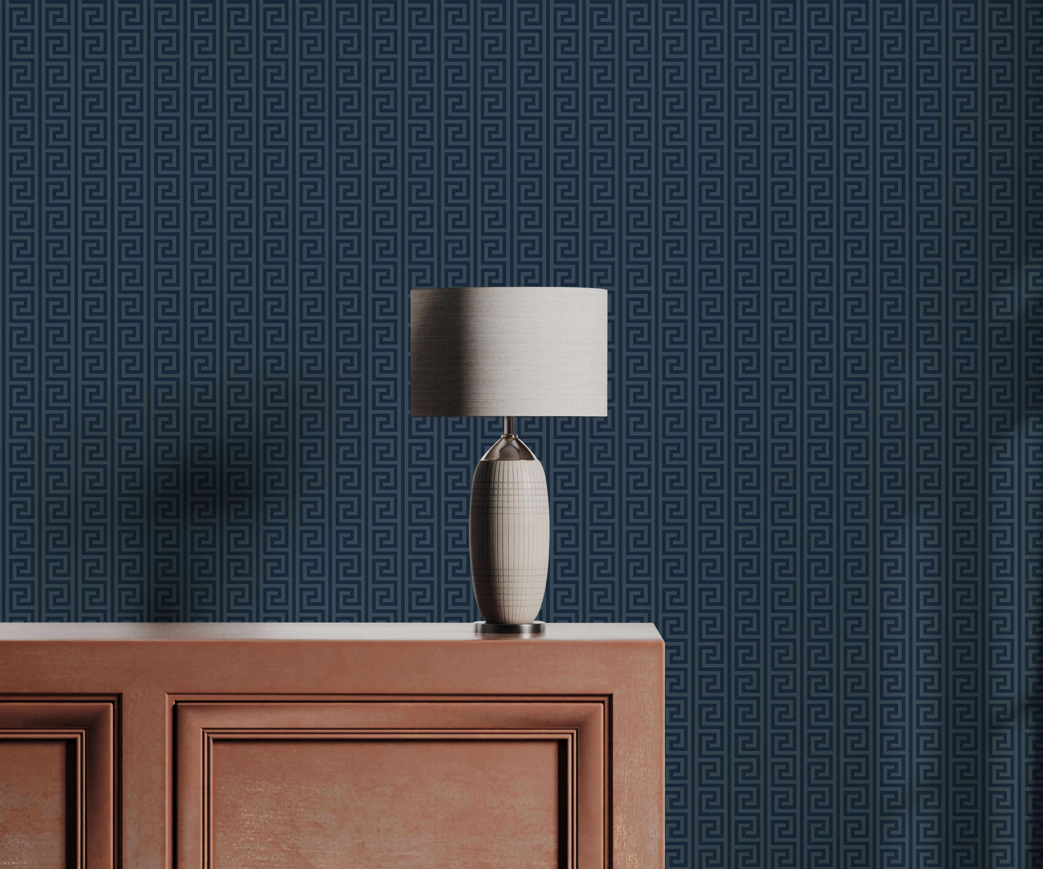 Table lamp on a wooden cabinet against a blue geometric patterned wall