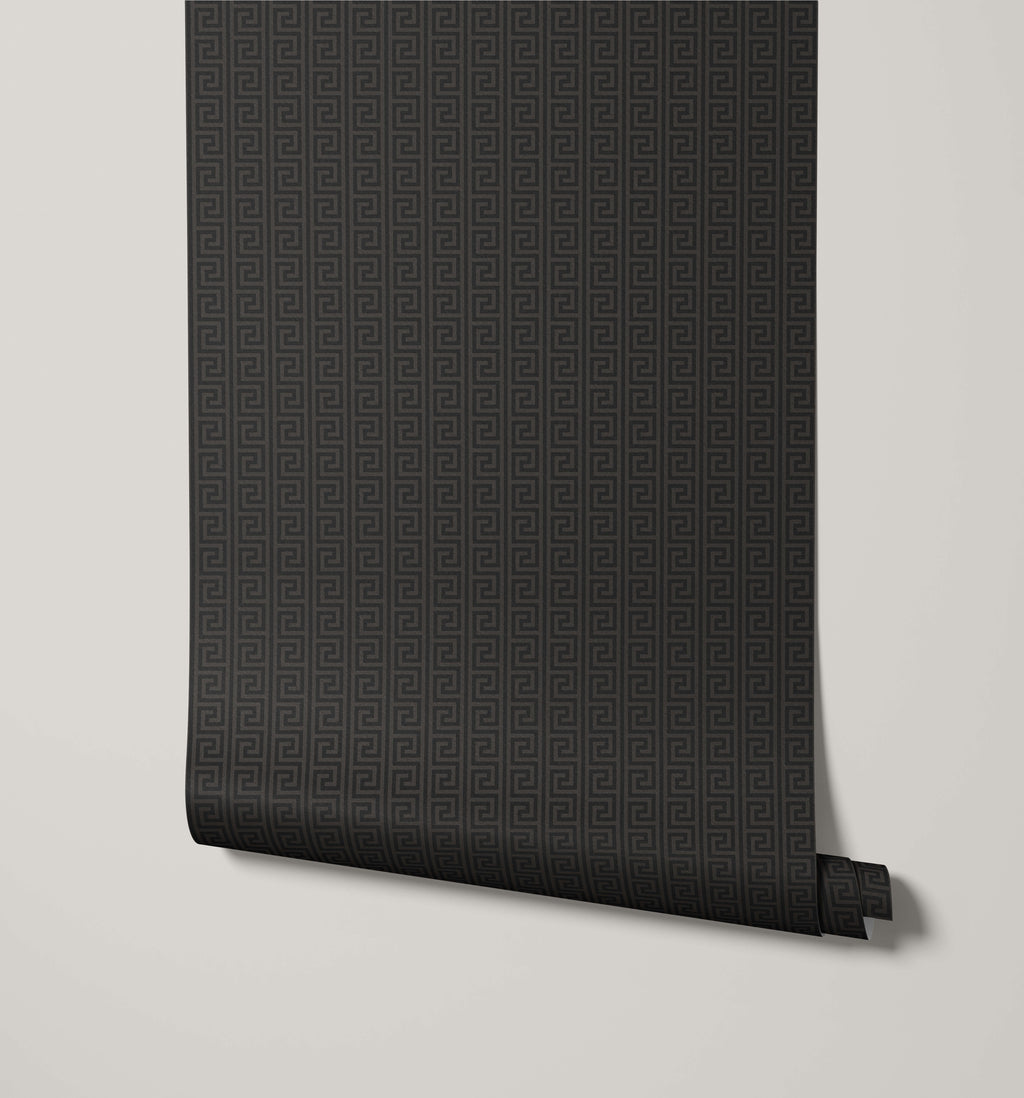 Roll of black textured wallpaper on a light gray background