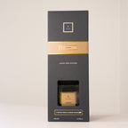 Black and gold box with a candle inside on a white background