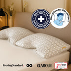 Patterned pillows on a bed with osteopath recommended and best pillow for side sleepers badges.