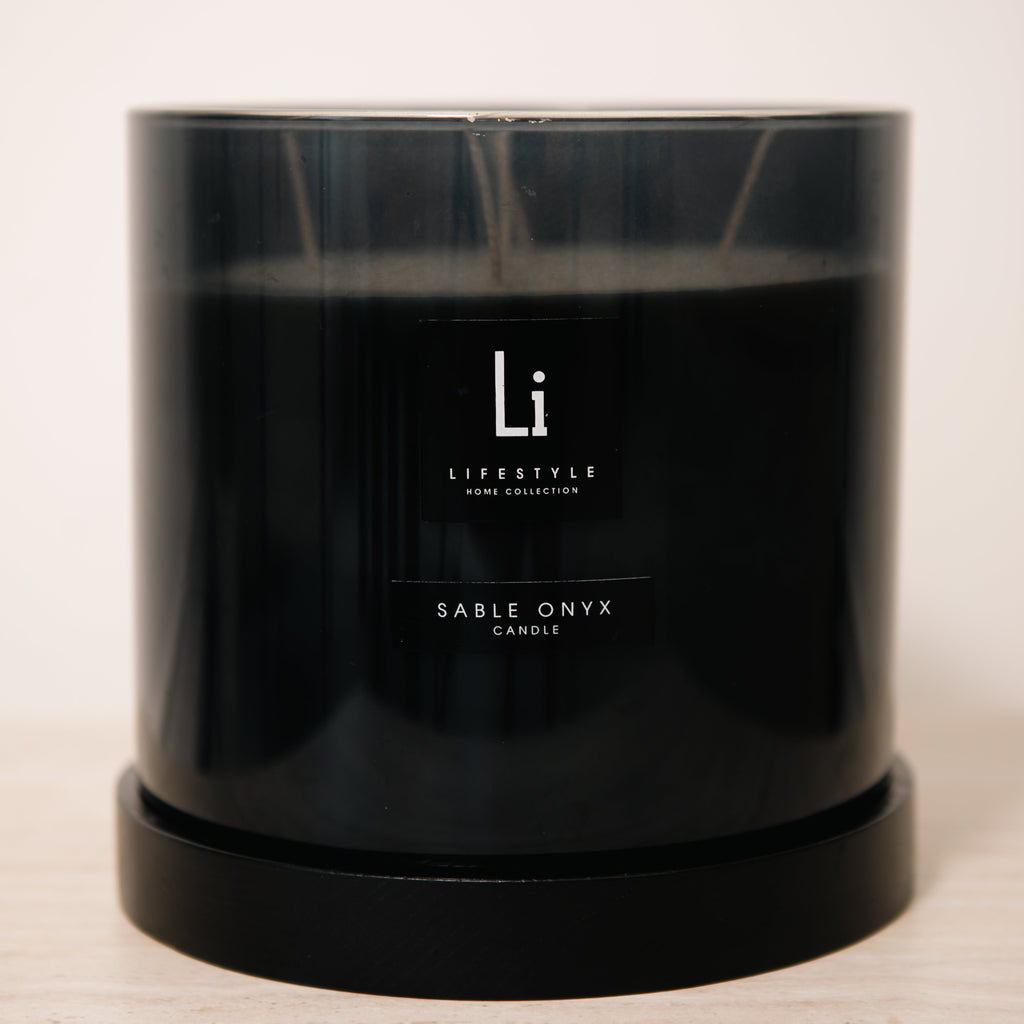 Black candle with 'Li Lifestyle' branding on a light background