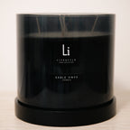Black candle with 'Li Lifestyle' branding on a light background