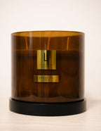 Brown candle with gold labels on a white background