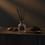 Reed diffuser with decorative elements on a dark surface