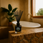Diffuser with black sticks on a stone surface in a bathroom setting