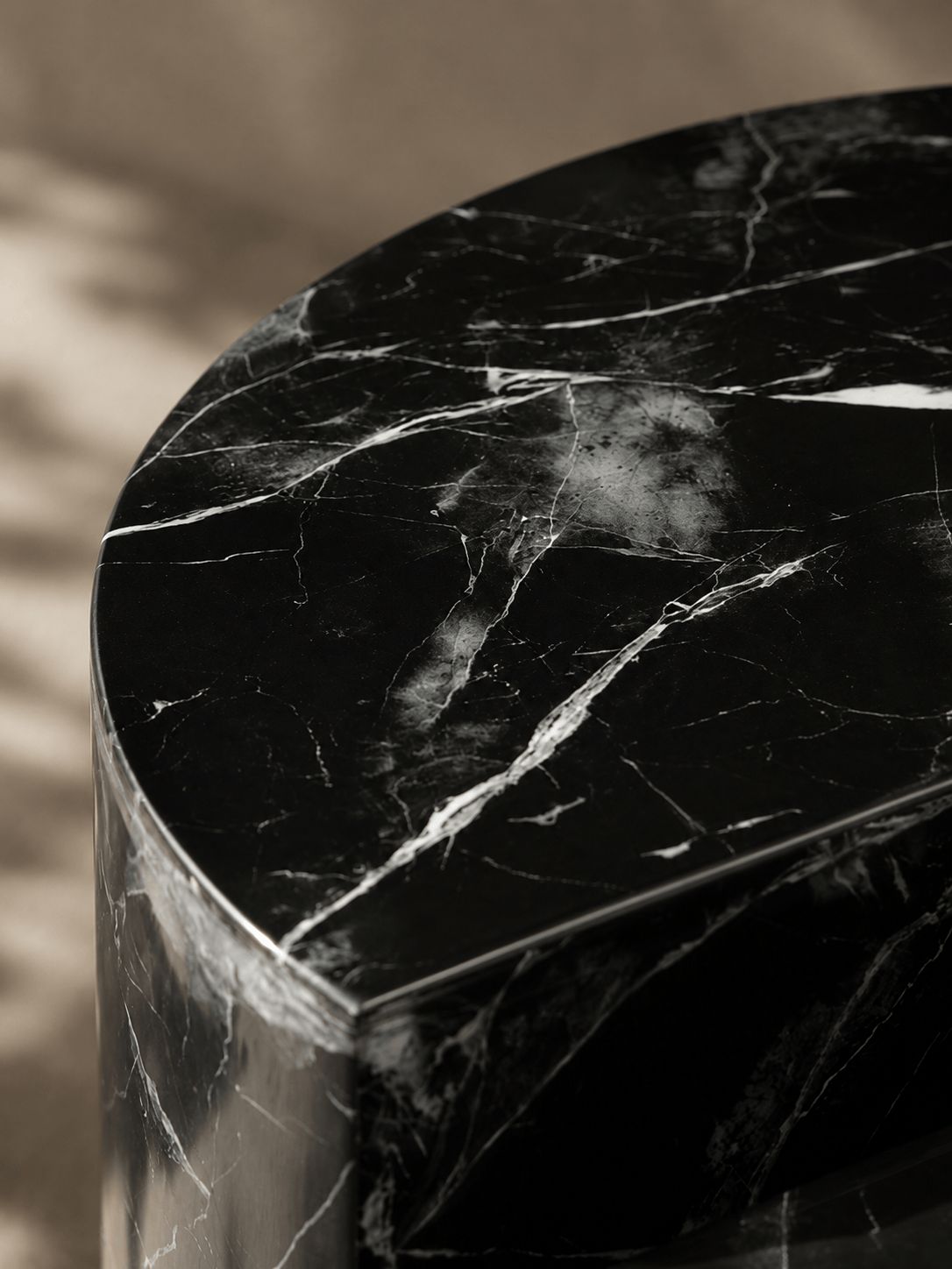 Black marble pedestal with a blurred background
