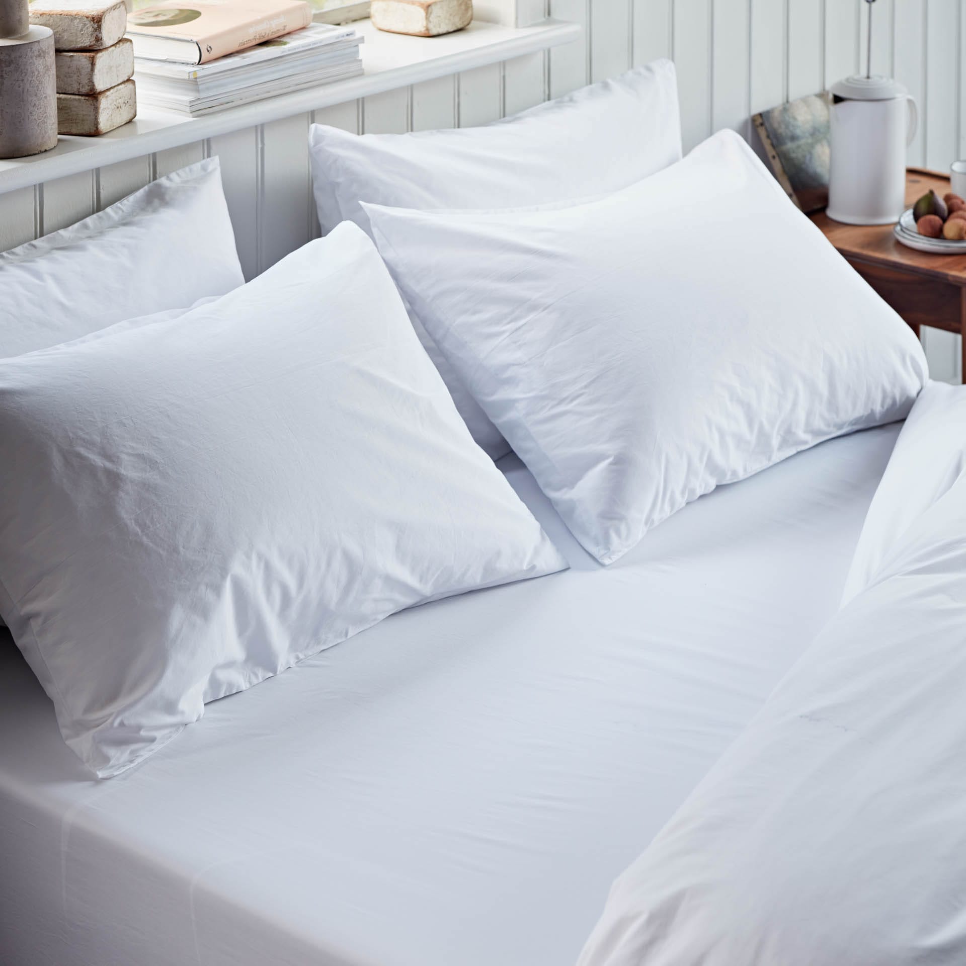 White pillows on a bed with a neutral background