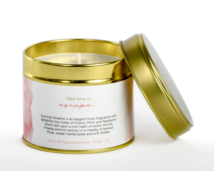 Candle in a tin with a gold lid on a white background