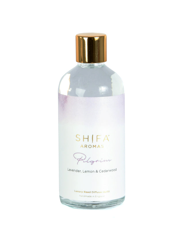 Shiha Aroma diffuser bottle with gold cap on a white background