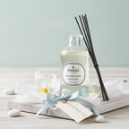 Parks diffuser bottle with reeds and decorative elements on a light surface