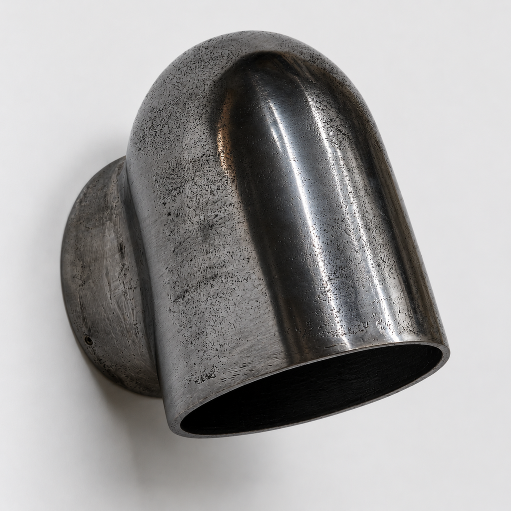 Metallic wall-mounted light fixture on a white background