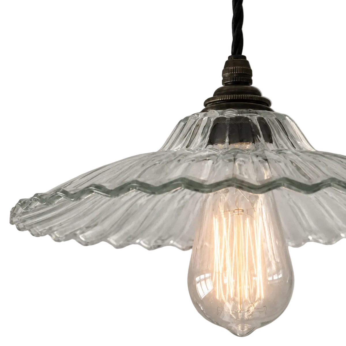Vintage-style pendant light with clear glass shade and visible bulb on a gray background